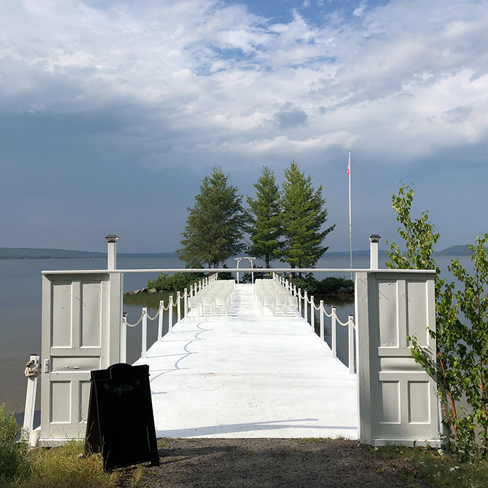 White doors opening onto the Lake Bernard wedding pier at The Northridge Inn and Resort